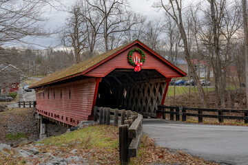 Historic timber one lane covered bridge in the Town of Newfield, Tompkins County NY with holiday lights.	