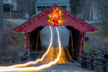 Light trails through a timber one lane covered bridge in the Town of Newfield, Tompkins County NY...