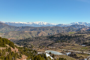 Naklejka premium Tian Shan mountains scenic view from the slopes of Amirsoy ski resort (Tashkent region, Uzbekistan) 