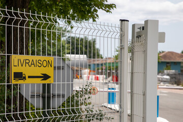 French text livraison means delivery and arrow sign truck direction access entrance in factory