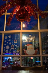 Festive decorations on a window indoors looking out
