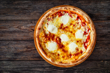 Margherita Pizza with tomato sauce and mozzarella cheese on wooden background. Top view 