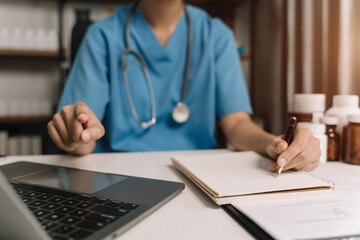 Medical Technology Concepts. Medical students use laptop computer to search for information in a modern office in the morning at the desk.