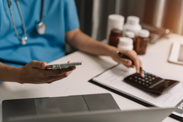Doctor use a service fee calculator to save money on health insurance, drug cost concept.