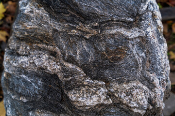 close up of decorative granite boulder with veins and cracks