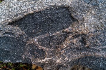 close up of decorative granite boulder with veins and cracks