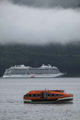 Luxury cruiseship cruise ship liner Orion and tender life boat in Hoonah Icy Strait Point Bay,...