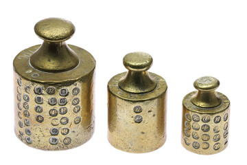 vintage brass weights with several calibration hallmarks isolated on white background