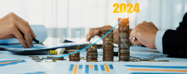 Growth coin stack symbolizing business investment and economic growth. Business people doing financial planning to achieve financial goal and contribute maximum profit on new year 2024 . Shrewd