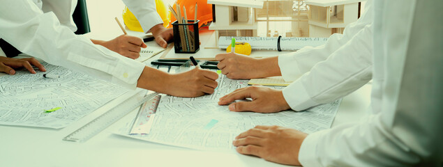 Worker, architect and engineer work on real estate construction project oratory planning with...
