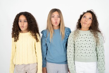 Three beautiful multiracial kid girls  making fish face with lips, crazy and comical gesture. Funny...