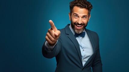 Portrait of cheerful businessman pointing at copy space 
