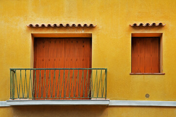 A fragment of the facade of a house with a balcony