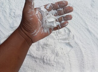 Snow-Covered Hand in a Blizzard. Frosty hand braving snowy blizzard with falling snowflakes.