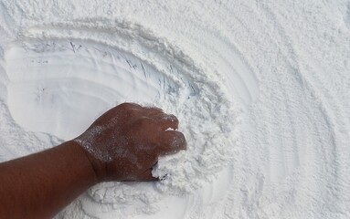Snow-Covered Hand in a Blizzard. Frosty hand braving snowy blizzard with falling snowflakes.
