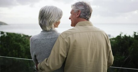 Senior couple, back and hug with a view of the ocean for travel, vacation or freedom together. Love, trust or security with an elderly man and woman on the balcony of their retirement beach house