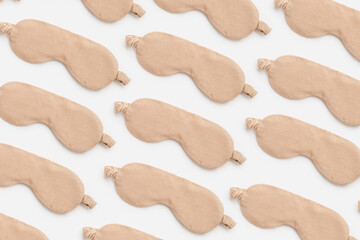 Minimal style pattern made from beige sleeping masks. Woman eye masks for best sleepers, for...