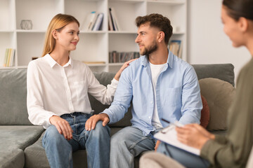 European husband and wife reconciling after marriage therapy session indoor - obrazy, fototapety, plakaty