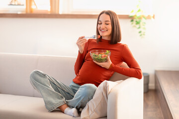 Cheerful Young Pregnant Lady Enjoying Fresh Vegetable Salad At Home
