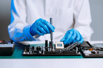 The technician repairing the motherboard in the lab with copy space. the concept of computer...