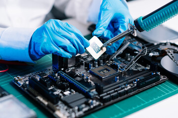 The technician repairing the motherboard in the lab with copy space. the concept of computer hardware, mobile phone, electronic, repairing, upgrade . - obrazy, fototapety, plakaty