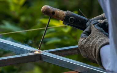 Red hot Welding bead, seam made by SMAW while welding due to liquify of the metal.