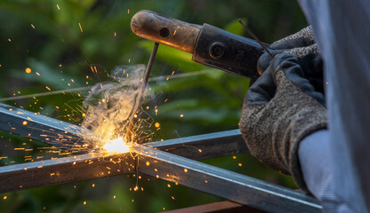 Blue spark of shielded metal arc welding with smoke and sparkling