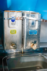 vats of liquids for consumption used by passengers on the Dakota DC-3l passenger plane on the...