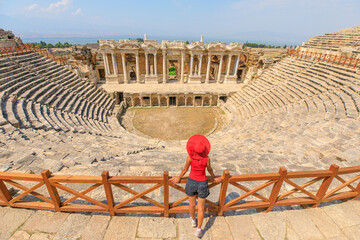 woman tourist at the theater of Hierapolis, situated within the ancient city of Hierapolis in Turkey, is a striking archaeological marvel that reflects the grandeur of Roman architecture. aerial view