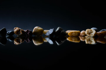 stones of various colors on black background