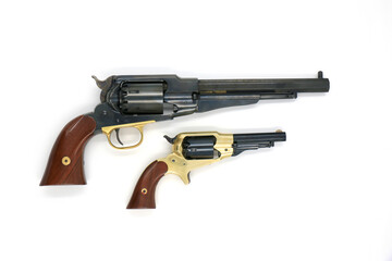 Remington 1858 New Army (cal.44) and Remington 1863 Pocket (cal.31) black powder percussion revolvers on a white background. Size comparison. Right side.