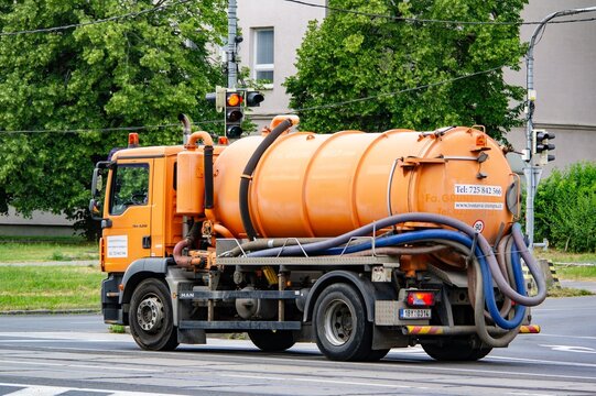 Orange TGM 18.250 cleaning truck on a street in Ostrava streets