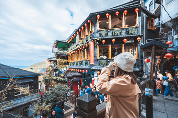 Naklejka premium Traveler asian woman travel and sightseeing in Jiufen old street market village at Taiwan