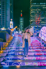 Naklejka premium Traveler asian woman travel and sightseeing in winter christmas light up illumination festival in Taipei Taiwan