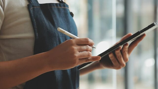 Startup successful small business owner sme beauty girl stand with tablet in coffee shop restaurant, asian tan woman barista cafe owner, entrepreneur seller business concept