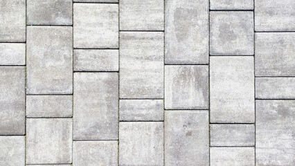  High-definition close-up of a grey stone paved road texture. - 690959038
