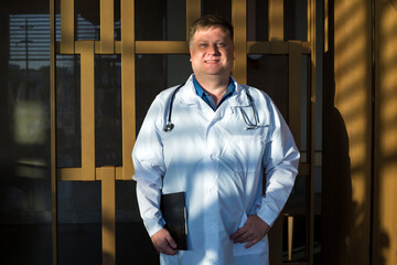 Head doctor of the hospital in the new renovated hospital full length portrait.