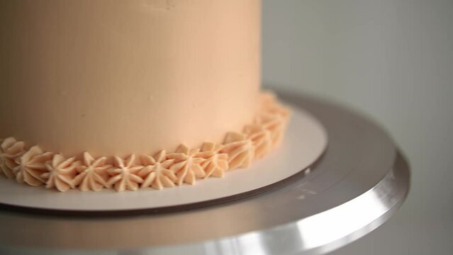 woman prepares cake and pastries. close-up of a cake.beige cake.slow motion video.High-quality shooting in 4K format