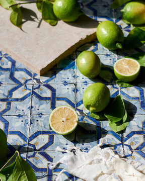 Turkish green limes 'Misket limonı' on blue tile background