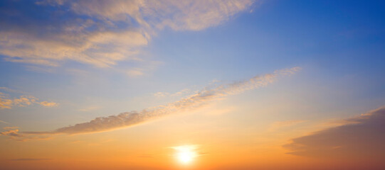 Sunrise sky in the morning with yellow sunlight and clouds on panoramic blue sky background