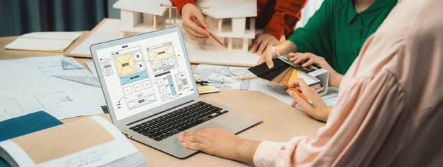 Cropped image of interior designer team discuss the material color while laptop displayed website...