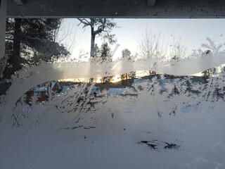 Christmas time, frost art on window in a cold day