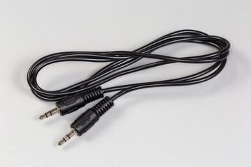 Analog audio cable with mini stereo connectors on gray surface