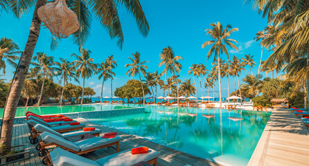 Relax tourism landscape. Luxurious beach resort with swimming pool and beach chairs or loungers leisure lifestyle, under umbrellas, palm trees, blue sky. Summer travel and vacation background concept
 - obrazy, fototapety, plakaty