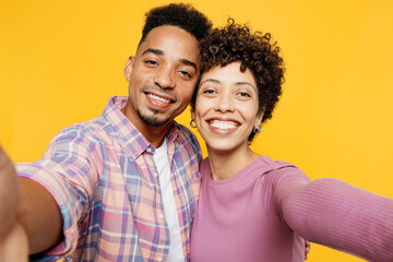 Close up young couple two friends family man woman of African American ethnicity wear purple casual...