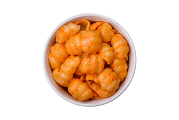 Delicious fresh pasta with pesto sauce, salt, spices and herbs on a ceramic plate