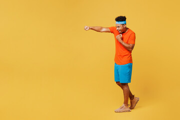 Full body young fitness trainer sporty man sportsman wearing orange t-shirt stretch hand pov...