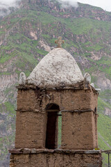 Fototapeta na wymiar Adobe Bell tower of a Christian church in a village around Sangalle, Canyon de Colca, Peru.