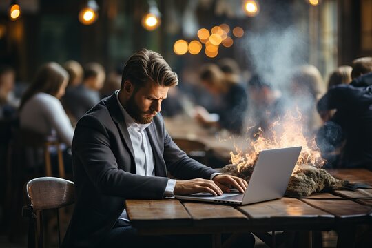 A man sits at a table and works at a computer, the concept of emotional burnout of a worker.