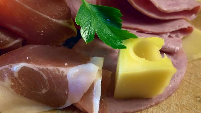 Cold Smoked Meat, jamon, sausage, cold meat, cheese. Plate, antipasto set platter wooden plate. Cold smoked meat plate with sliced ham, prosciutto, bacon